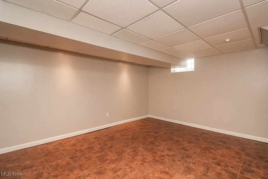 Below grade area featuring a paneled ceiling