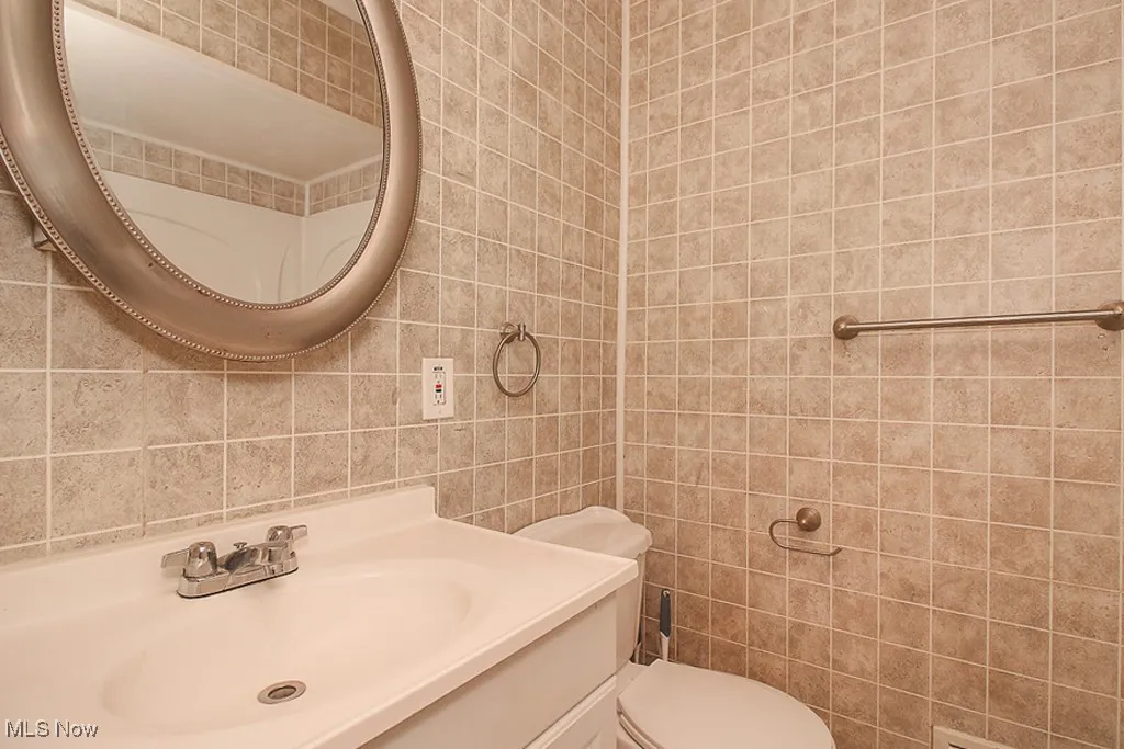 Bathroom with tile walls and vanity