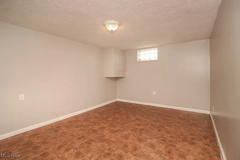 Basement with a textured ceiling