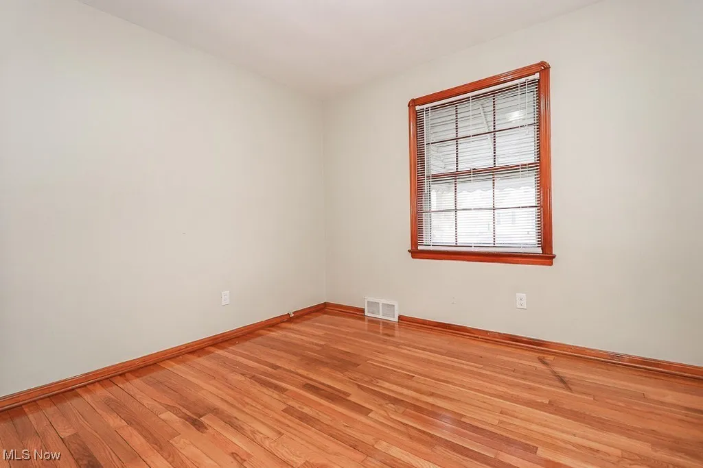 Unfurnished room featuring light wood-style floors and baseboards