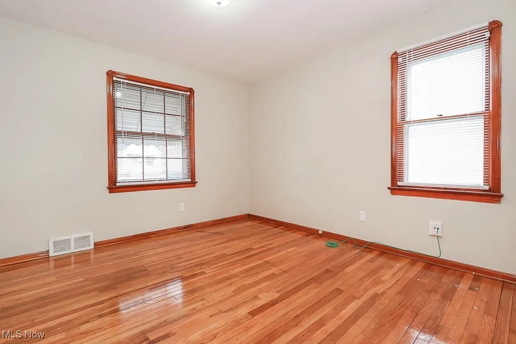 Spare room featuring light wood finished floors and baseboards