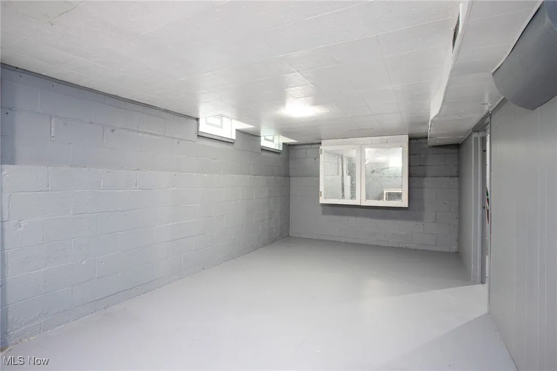 Below grade area featuring concrete block wall