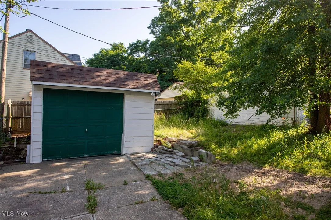 Detached garage featuring concrete driveway