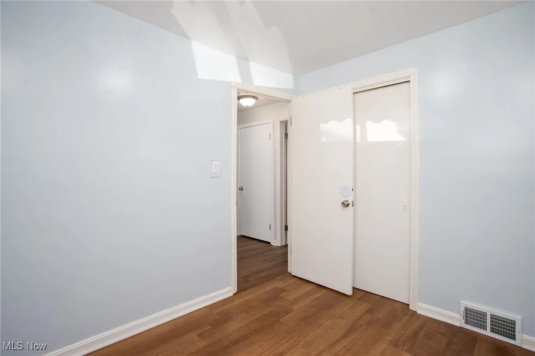 Empty room with wood finished floors and baseboards