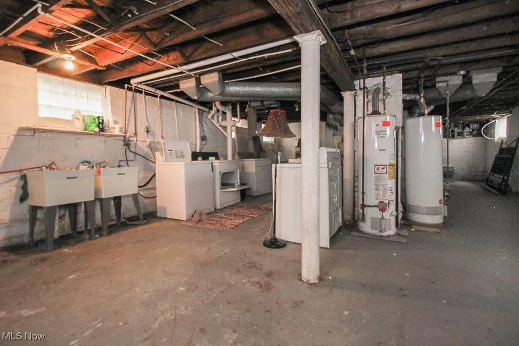 Below grade area with gas water heater and washer and dryer