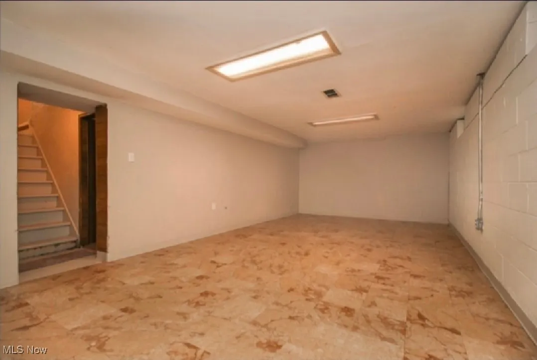 Finished basement featuring stairs