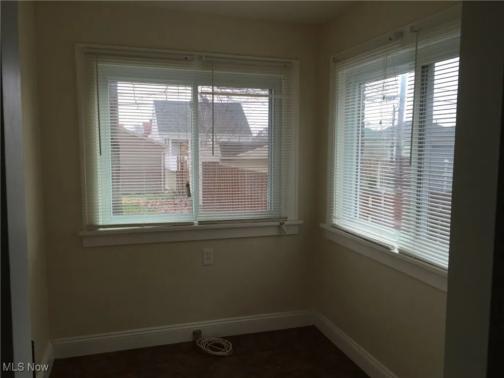 Unfurnished dining area with baseboards