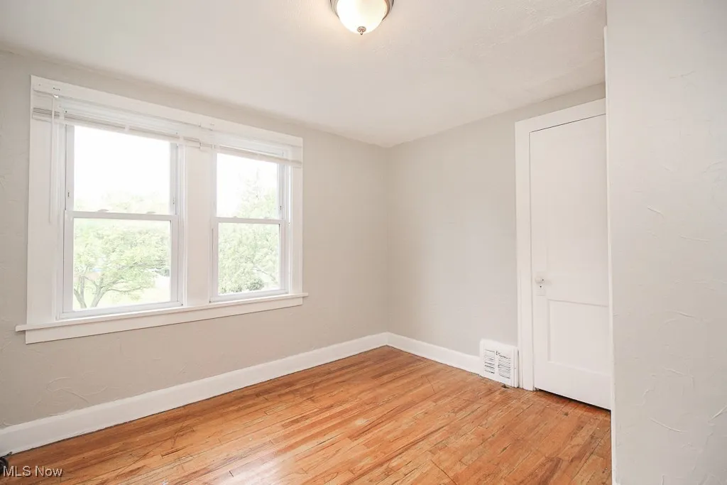 Spare room with light wood finished floors and baseboards