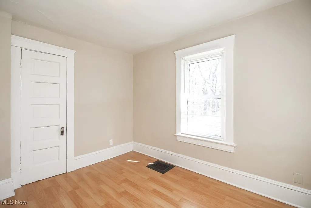 Unfurnished room featuring light wood-style flooring and baseboards