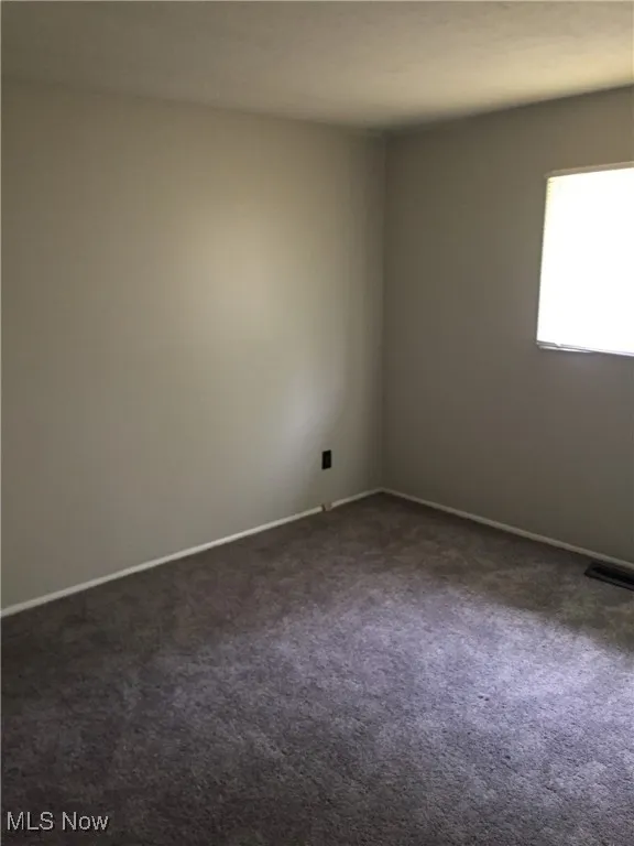 Empty room with dark carpet