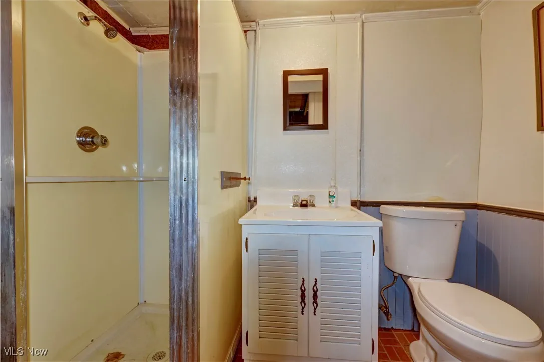 Full bathroom featuring a stall shower and vanity