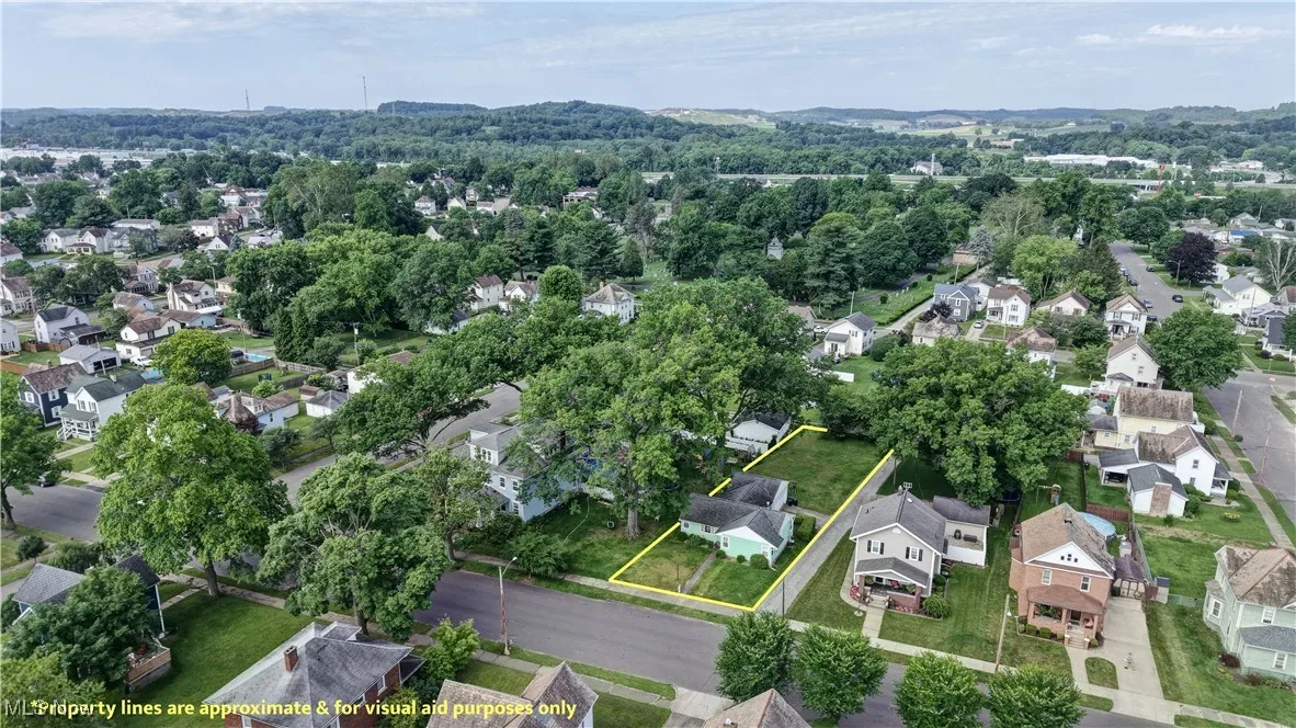 Aerial view of residential area with property parcel outlined