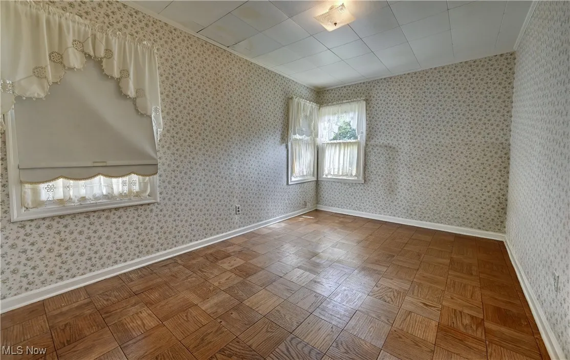 Empty room featuring baseboards