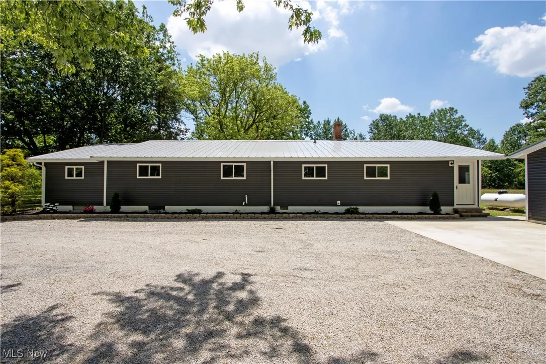 Back of property featuring a metal roof