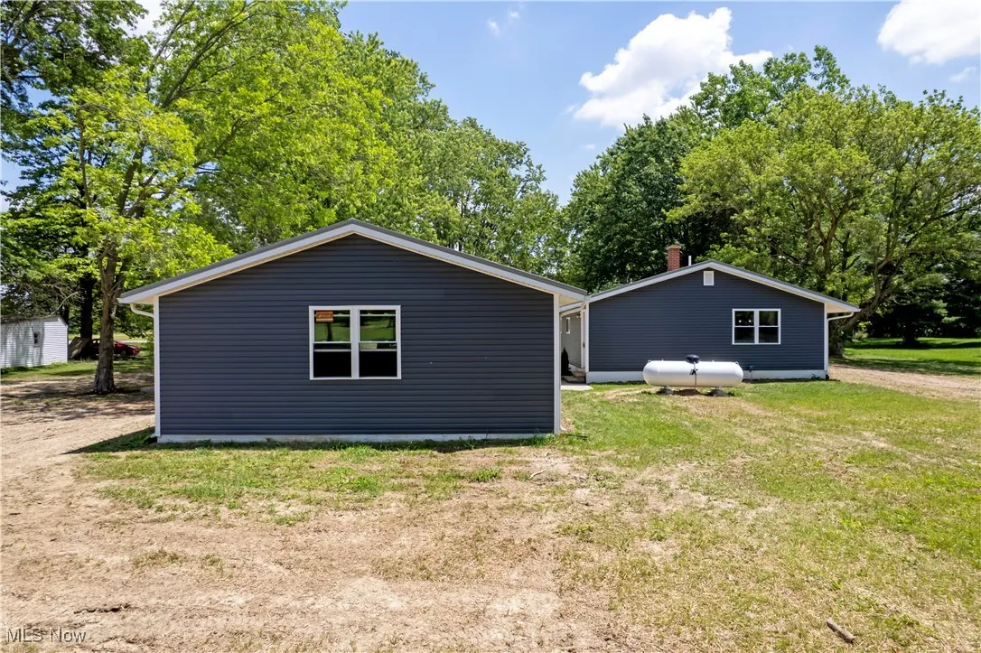 View of side of home featuring a lawn