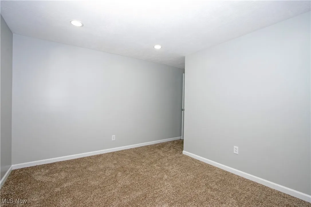 Spare room with carpet floors and recessed lighting