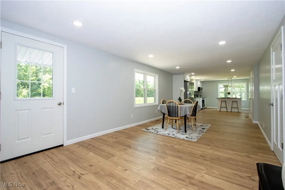 Dining room with recessed lighting and light wood finished floors
