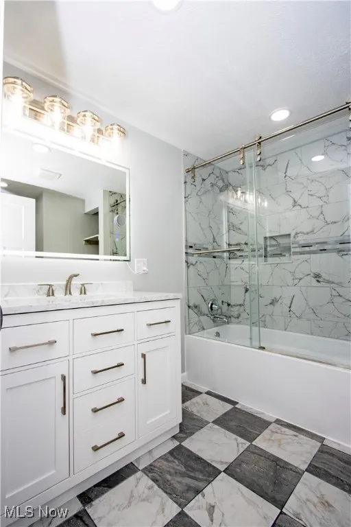 Full bathroom featuring vanity and combined bath / shower with glass door