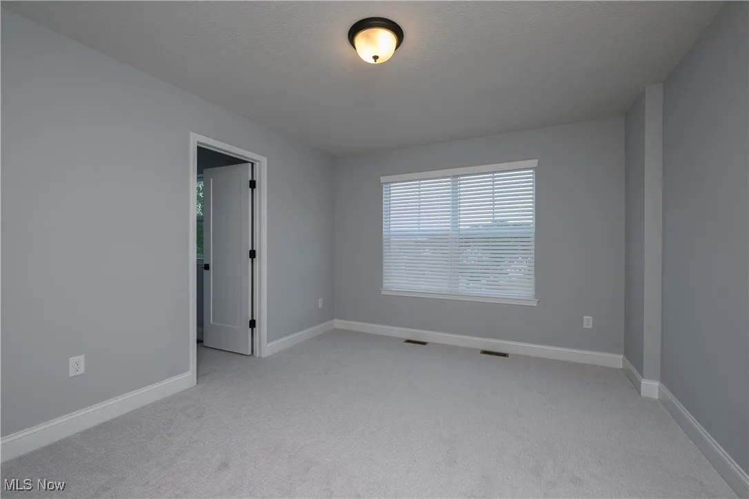 Spare room featuring carpet flooring