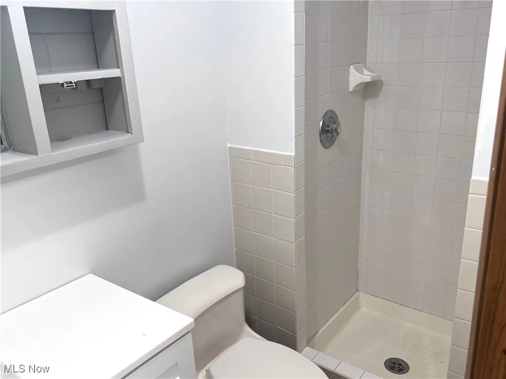 Bathroom with a stall shower and vanity