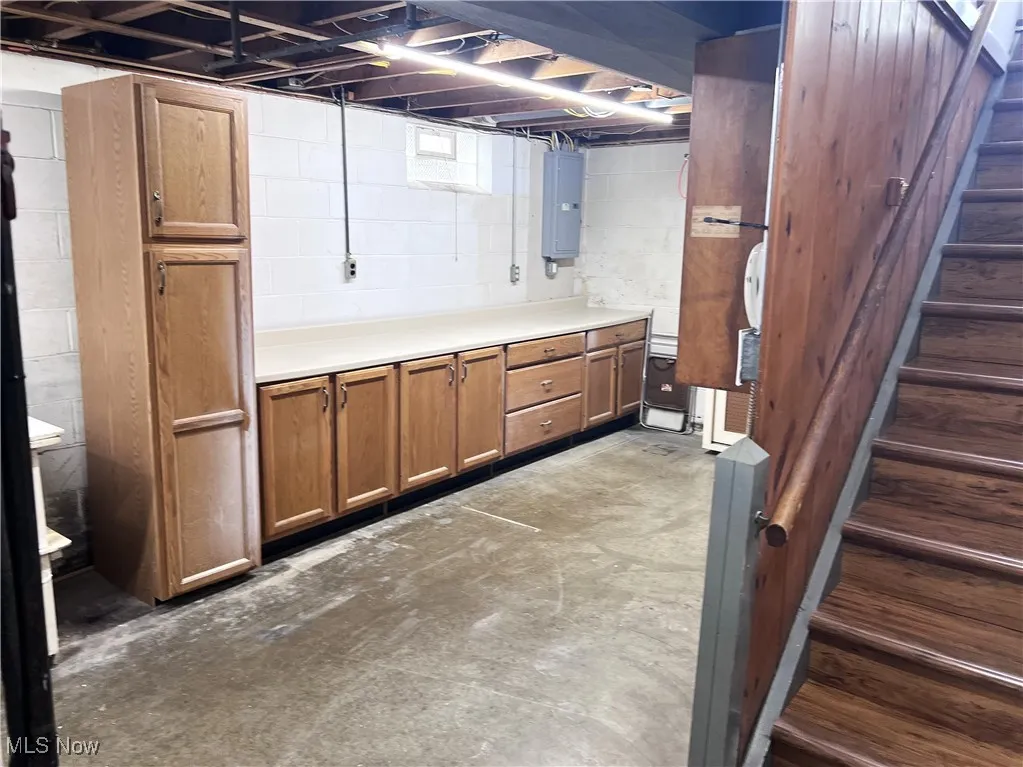 Basement featuring stairway and electric panel