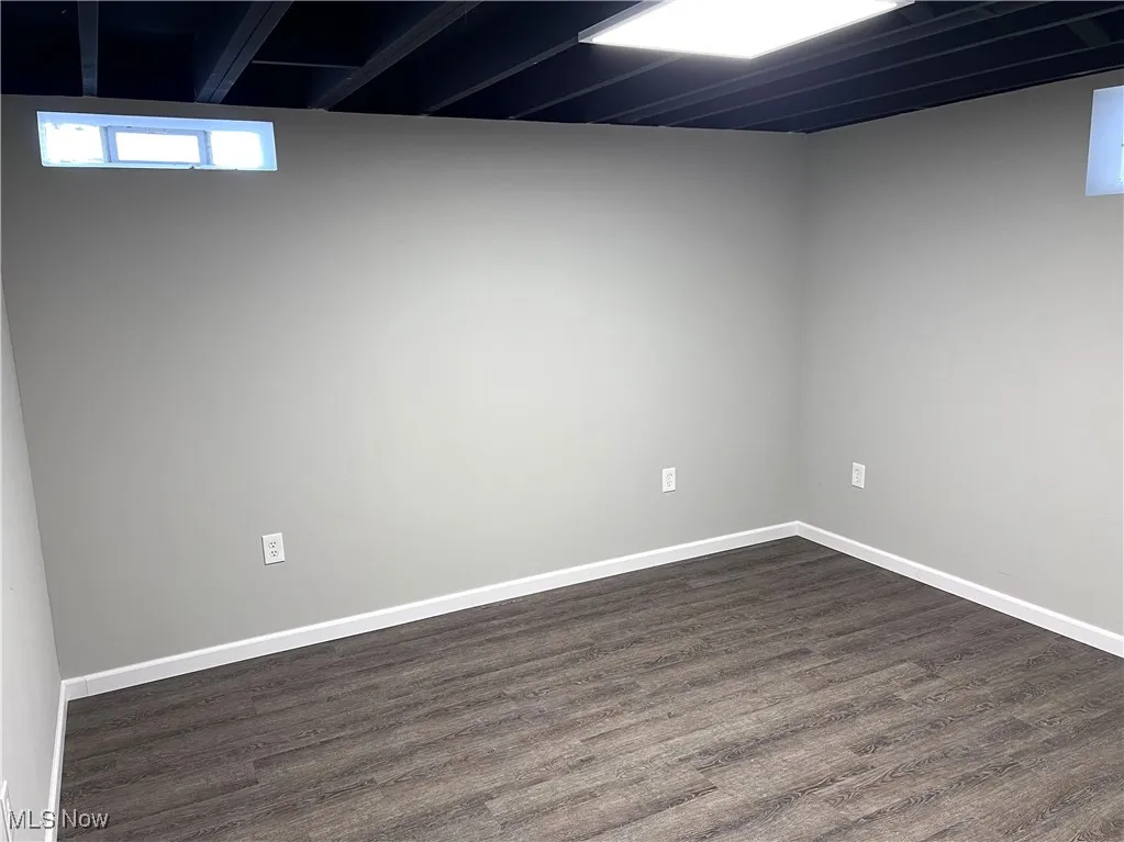 LL bedroom 4 with dark wood VLT-style floors and baseboards