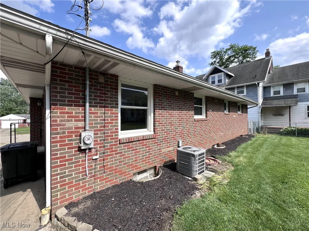 View of property exterior featuring brick siding