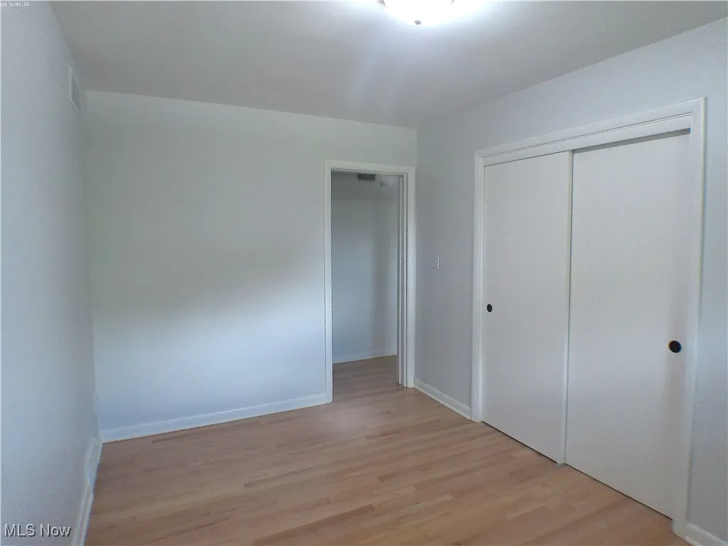  Bedroom 3 with refinished Oak wood finished floors and a closet