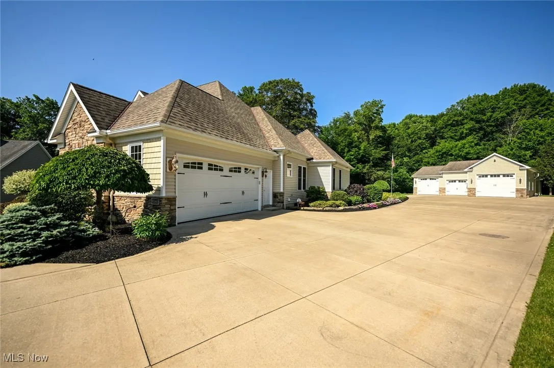 Driveway access to attached 2 car garage and detached multi car garage.