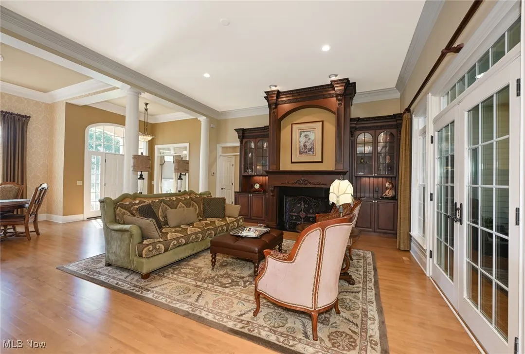 Living room with hardwood floor and black walnut fireplace surround.