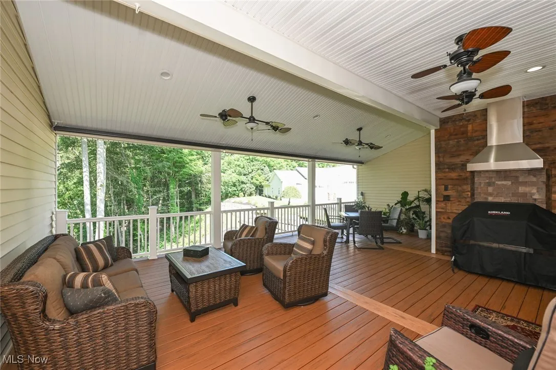 Covered deck off the living room with outdoor cooking area.