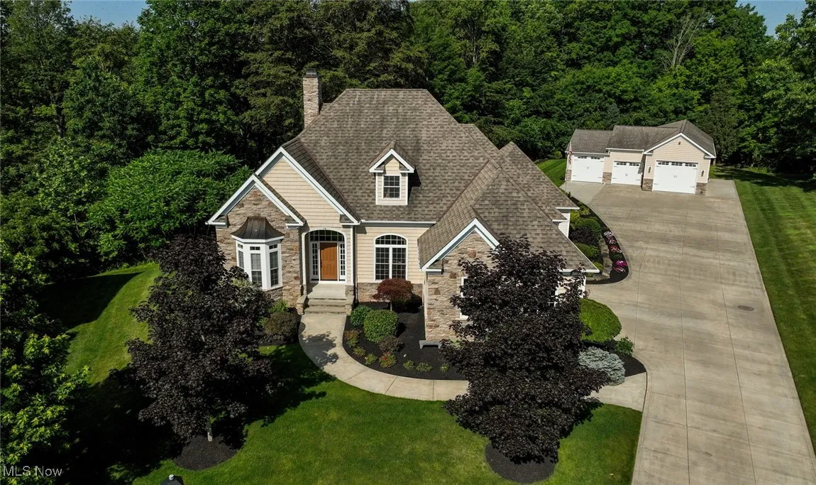 Aerial showing home and rear garage/shop.