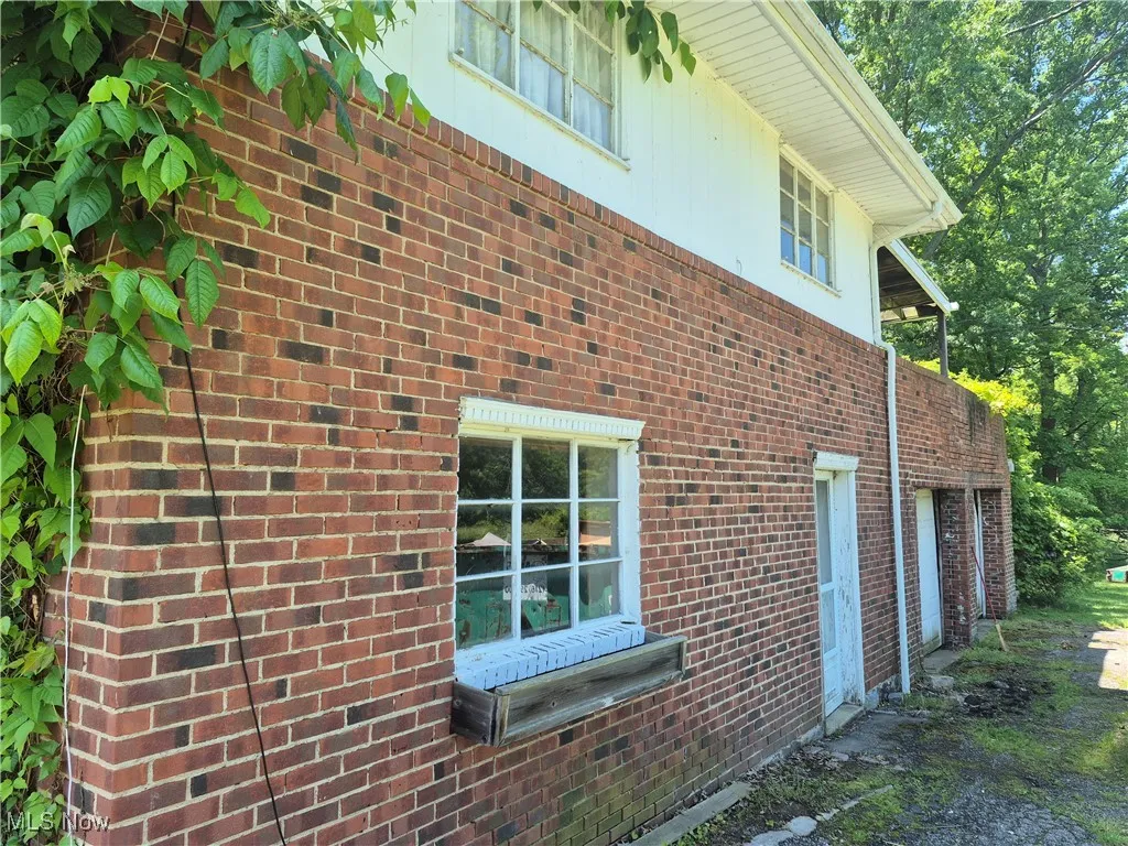 View of side of property with brick siding