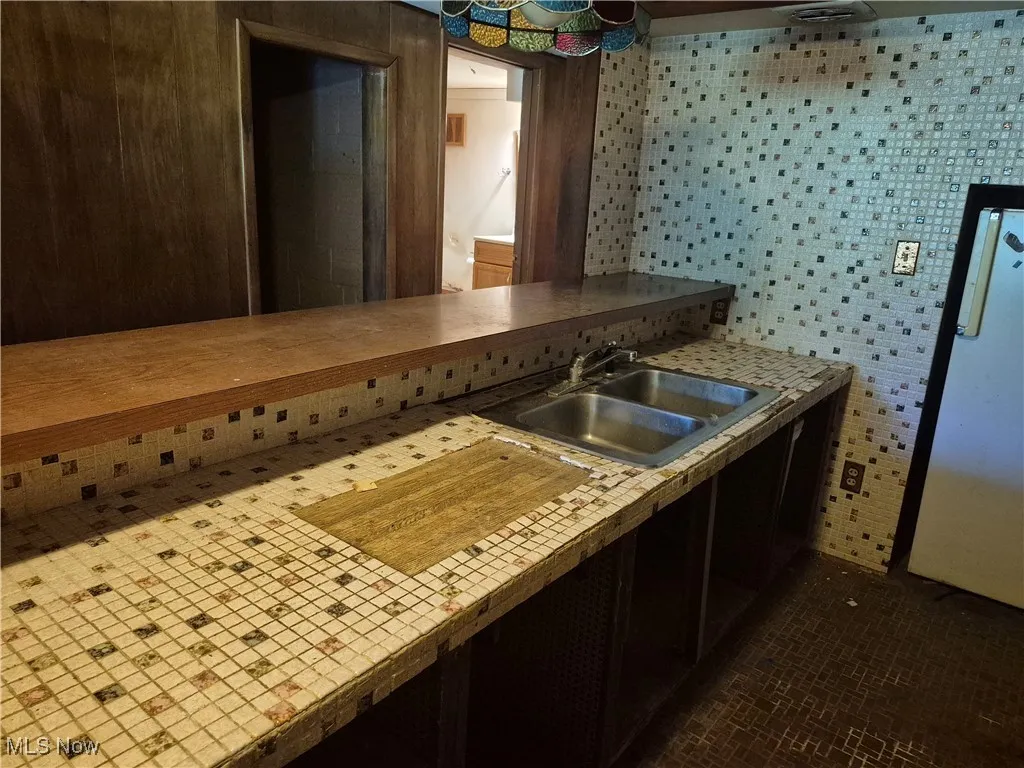 Kitchen with light countertops and brick patterned floors