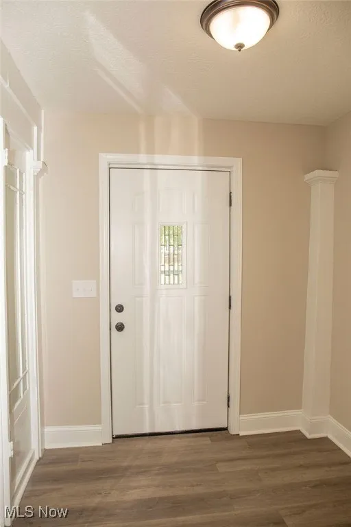Foyer entrance featuring wood finished floors and a textured ceiling