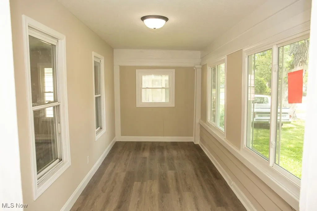 Unfurnished room featuring wood finished floors and healthy amount of natural light