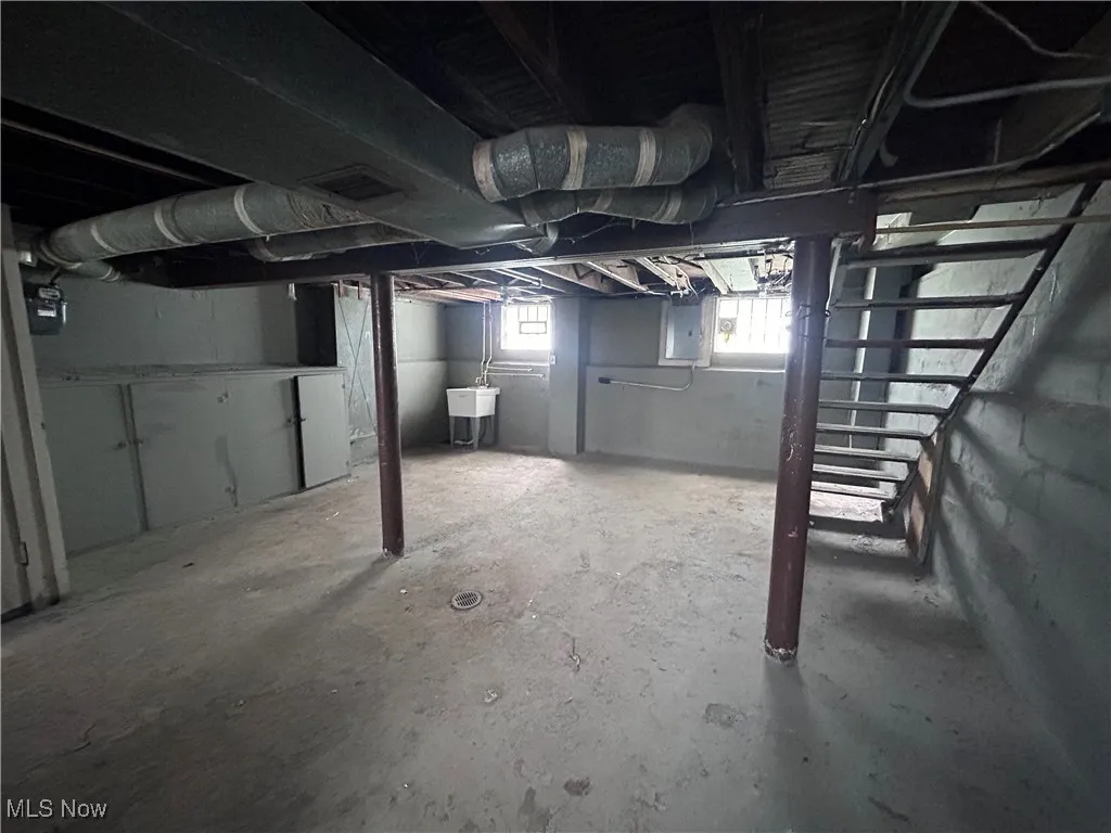 Below grade area featuring a sink and electric panel