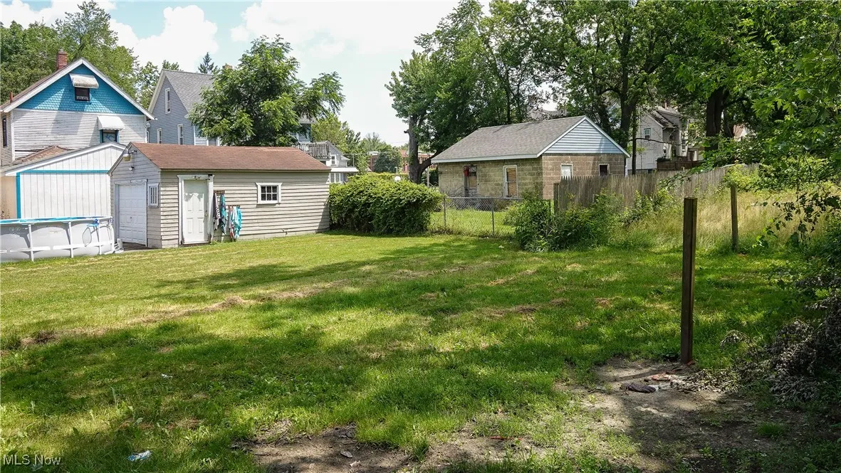 View of yard with an outbuilding and a garage