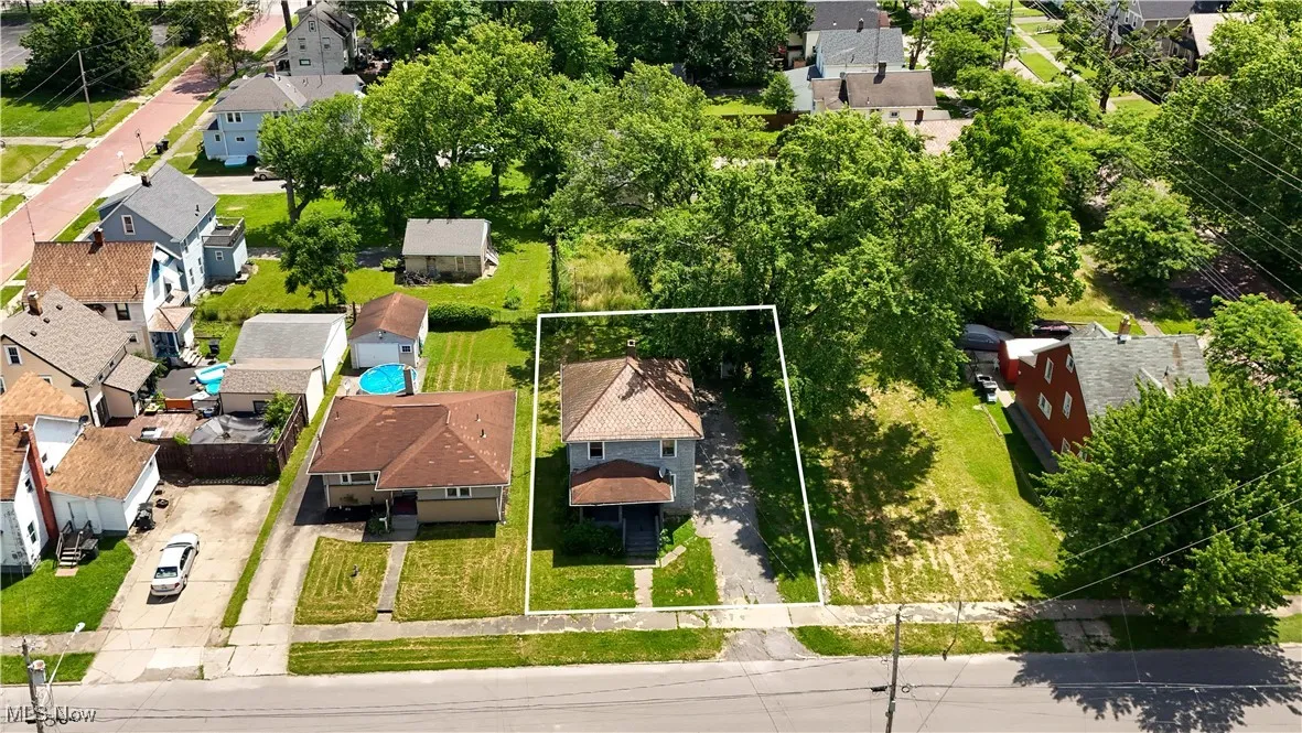 Aerial view of residential area with property parcel outlined