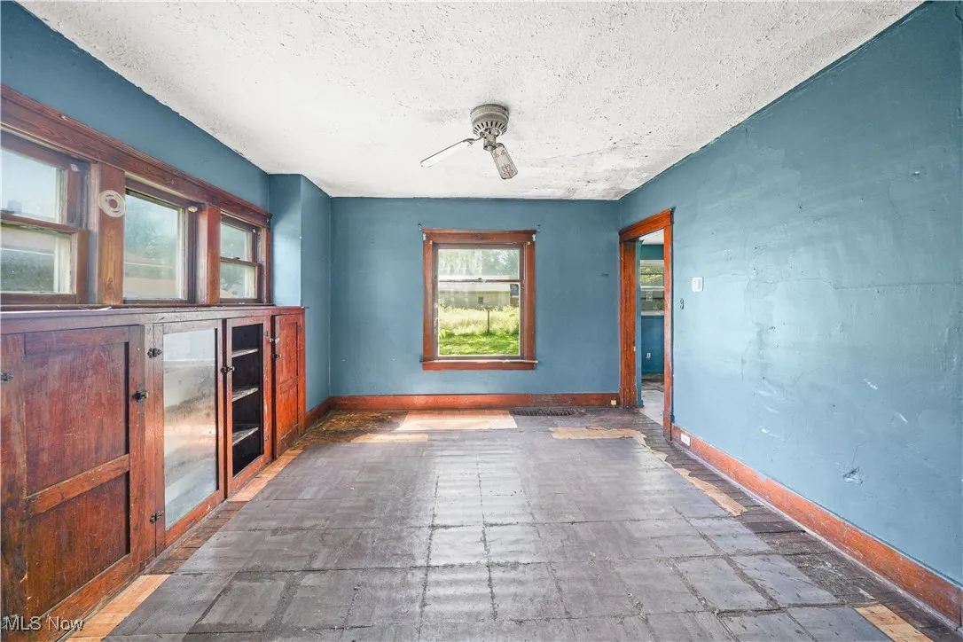 Spare room featuring a ceiling fan, a textured ceiling, and stone finish flooring