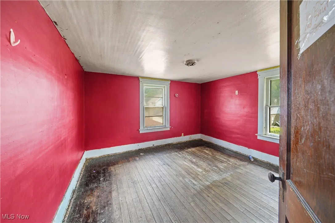 Unfurnished room featuring wood-type flooring and baseboards