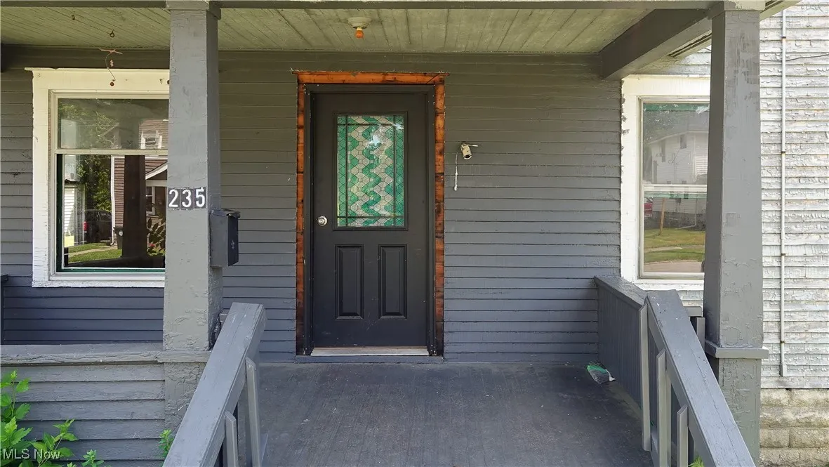 View of exterior entry featuring a porch