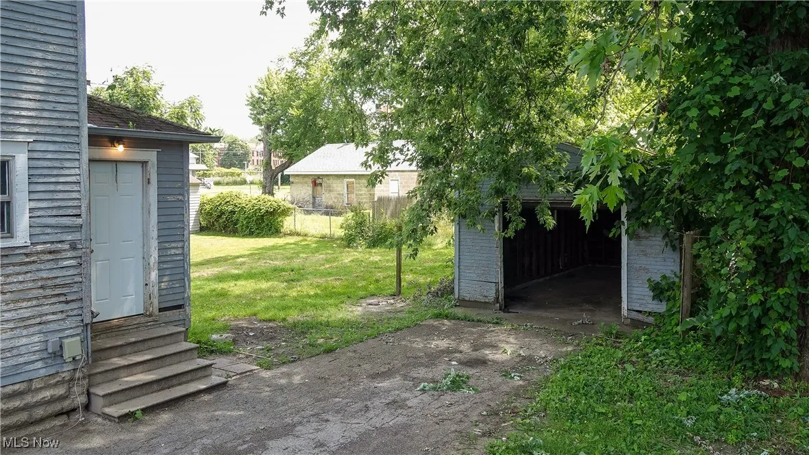 View of yard with an outdoor structure and entry steps