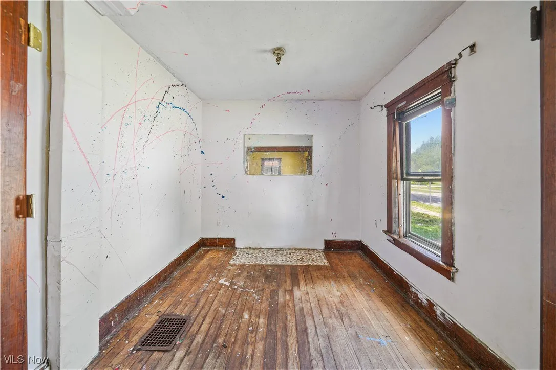 Spare room with hardwood / wood-style flooring and baseboards