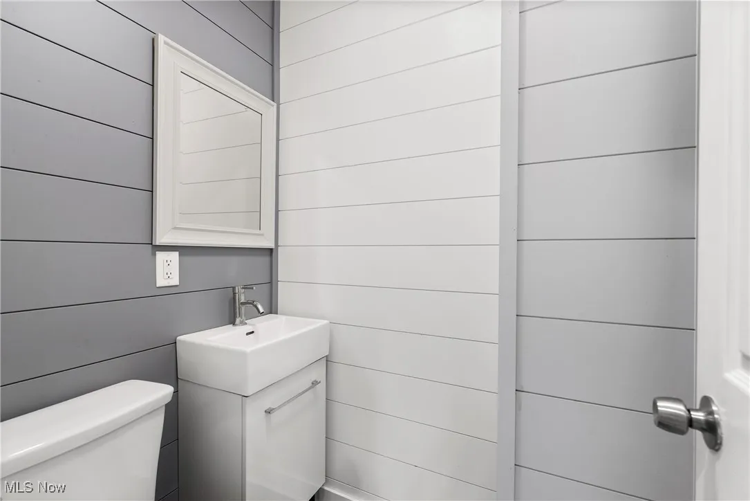 Bathroom featuring vanity and wooden walls