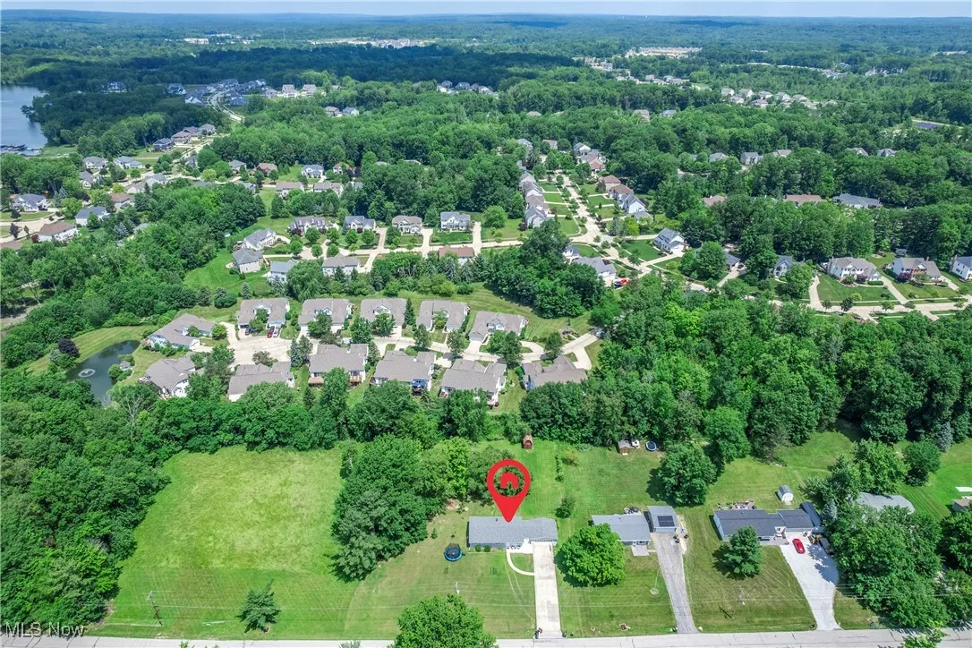 Aerial overview of property's location with a nearby body of water and nearby suburban area