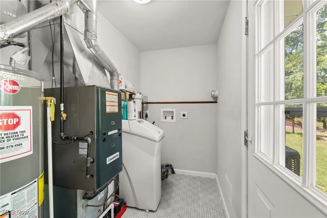 Utility room with water heater and washer / dryer