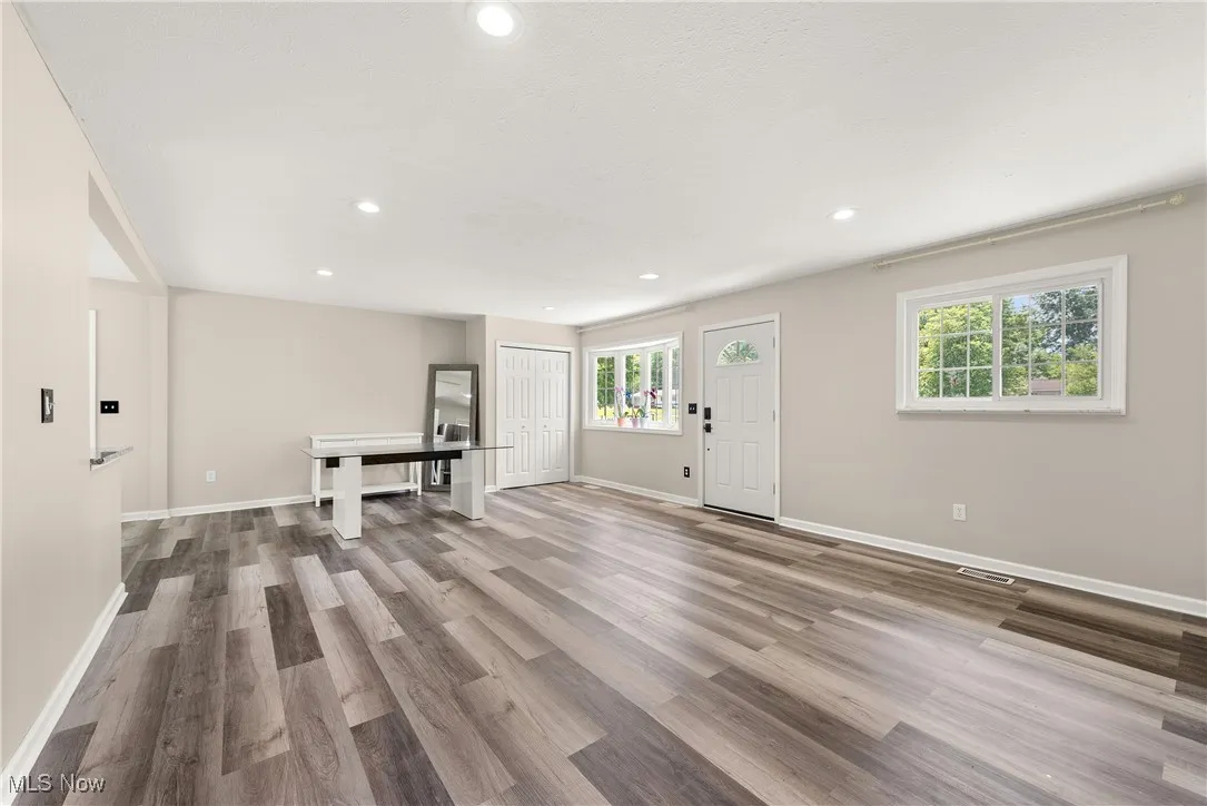 Entryway with recessed lighting and wood finished floors