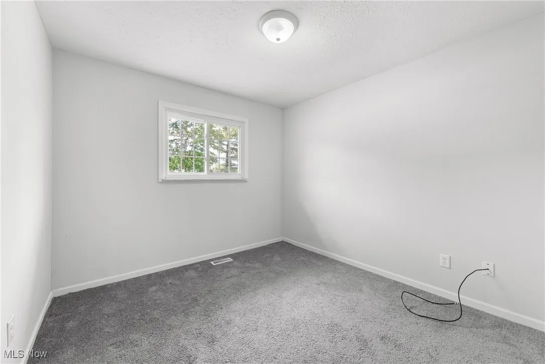 Spare room with carpet and a textured ceiling
