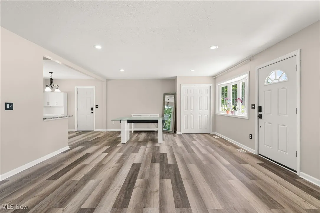 Foyer entrance featuring wood finished floors and recessed lighting